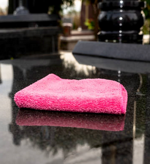 A cleaning cloth on a polished headstone