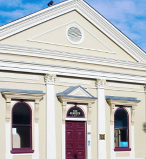 A heritage building facade with a QR plaque
